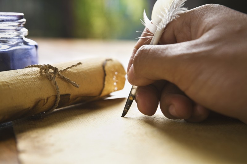 Writing hand with feather