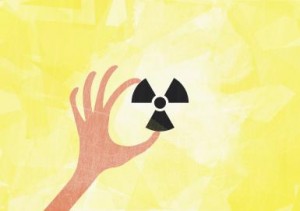 A hand holding a radioactive symbol